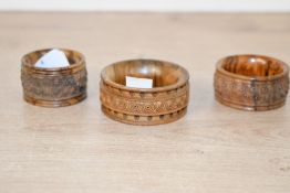 Three vintage Jerusalem carved coquilla nut napkin ring holders, each of flared form and decorated