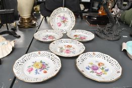Six vintage Cruse and Company fine porcelain hand painted decorative plates, featuring pierced