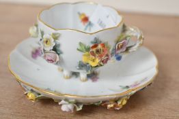 A late 19th-century Meissen porcelain demitasse cup and saucer duo, featuring delicate flower