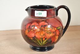 A mid-20th-century William Moorcroft 'African Lily' ewer-form vase, decorated with tube-lined floral