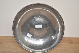 A vintage L.R.I Borrowdale hand beaten stainless steel decorative charger, featuring engraved floral