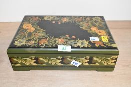 A wooden floral motif jewellery box, containing an assortment of eastern Asian jewellery and hair