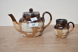 Two 19th-century Royal Doulton Lambeth salt-glazed stoneware teapot and milk creamer, having