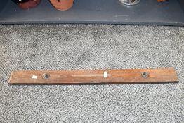 An early to mid 20th-century wooden spirit level, having brass ends and fixtures, unmarked, 91.