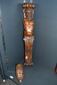A Victorian carved walnut figural pilaster, modelled to depict a semi nude male figure with floral