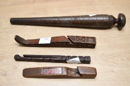Of ethnographic interest, a selection of wooden hand carved tools, featuring geometric detailings of