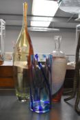 Two vintage Kjell Engman for Kosta Boda studio art glass bottles, featuring a tall yellow and deep