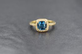 An 18ct gold topaz and diamond set ring, the central rose cut blue topaz in a pave diamond chip