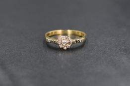 An 18ct gold diamond set cluster ring, the nine diamonds in a daisy motif cluster, having two