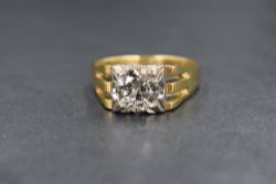 An 18ct gold diamond set signet style ring, the central round brilliant cut diamond measuring