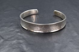 A contemporary silver cuff bangle, having a minimalist design, marked 925, 37.5g