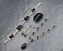A Whitby jet & silver necklace having ten jet panels in silver mounts with a further drop all on a