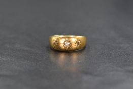 An 18ct gold diamond set gypsy ring, the band having three star set diamonds, marked 18 with