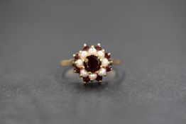 A gold red paste and pearl set cluster ring, the central round cut paste in an eight pearl