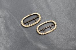 A pair of yellow metal presumed gold pearl set buckles, measuring approximately 2.5cm L x 1.9cm W,
