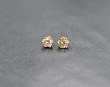 A pair of yellow metal brilliant cut diamond stud earrings in 6 claw set mounts, approx 0.40ct