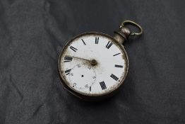 A George V silver open face key wound pocket watch, white dial having Roman numerals and