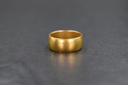 A 22ct gold band, of plain rounded form, marked 22ct with hallmarks, ring size L-M, 8.2g
