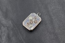 A Victorian silver locket, of rectangular form having gilt floral decoration to the front, marks for