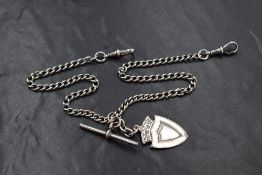 A silver curb link watch chain, having two dog clips, T-bar and shield medallion, 26.3g