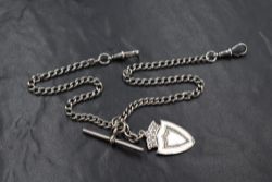 A silver curb link watch chain, having two dog clips, T-bar and shield medallion, 26.3g