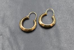 A pair of 9ct gold hoop earrings, having moulded triangular decoration, marked 375, 1.8g