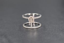 An 18ct white gold Messika Glamazone two row diamond ring having a central oval claw set diamond