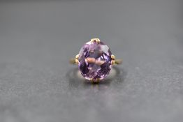 A 9ct gold amethyst set solitaire ring, the oval cut amethyst measuring approximately 13mm x 11mm