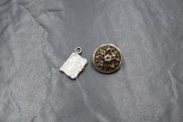 A white metal Art Nouveau locket, of rectangular book motif having a maiden and iris to the front,