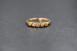 A yellow metal presumed gold diamond set half eternity ring, the five round brilliant cut diamonds