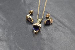 A 14ct gold diamond and possibly iolite set suite of jewellery, the pendant having a trillion cut