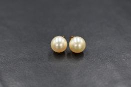 A pair of yellow metal cultured pearl stud earrings
