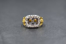 An 18ct gold gold diamond set ring, the central rectangular panel lacking enamel insert, with a