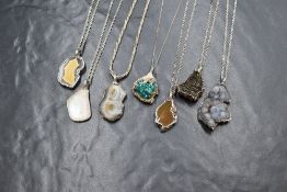 Seven assorted polished mineral pendants all in silver artisan style mount and all on silver