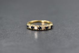 An 18ct gold diamond and sapphire set half eternity band, the five round cut sapphires alternating