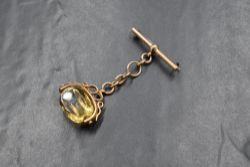 A 9ct gold citrine set spinner fob, in a scroll mount on a T-bar brooch, marked 375, 14.4g