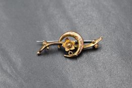 A 9ct gold bar brooch, of scroll form having a crescent moon and floral decoration, marked 375, 1.