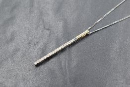 A 9ct gold diamond set pendant, the diamonds in a vertical setting, marked 9k, on a 9ct white gold