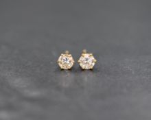 A pair of 18ct gold brilliant cut diamond stud earrings in 6 claw set mounts, approx 0.66ct total,