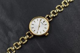 A lady's 9ct gold wrist watch by Seiko having a baton numeral dial to champagne coloured face in a