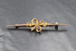 A 9ct gold seed pearl bar brooch having a naturalistic central pearl set bow, Chester 1911, 3.2g