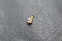 A 14ct gold diamond solitaire set pendant, the round brilliant cut champagne coloured diamond