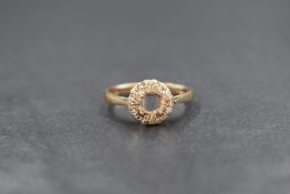 A 9ct gold ring setting, missing the central stone within an illusion diamond chip setting, marked