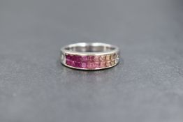 An 18ct white gold sapphire set band, the square cut ombre white to pink sapphires with round