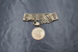 A 9ct gold six bar gate bracelet, having a large lobster clasp and a large 14ct gold coin having the