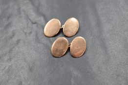 A pair of 9ct rose gold cufflinks, the plain oval panels having chain links, marked 375, 8.3g