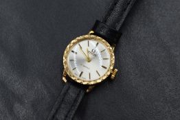 A 9ct gold Titus wristwatch, the champagne dial having baton five minute markers with decorative