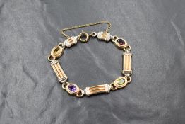 A 9ct gold gem set bracelet, the moulded panels interspersed with bezel set oval cut citrine,