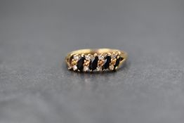A 9ct gold sapphire and diamond set band, the five marquise cut sapphires interspersed with eight