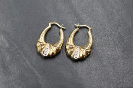 A pair of 9ct gold hoop earrings of moulded form, 2.2g